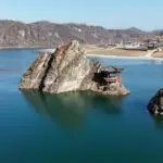 Panoramic view of 도담삼봉 in Danyang, South Korea, with three iconic rock peaks rising from the river surrounded by lush mountains.