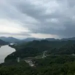 Scenic landscape view from the observation deck of 만천하스카이워크 in Danyang, South Korea, featuring winding river, forested mountains, and expansive sky.